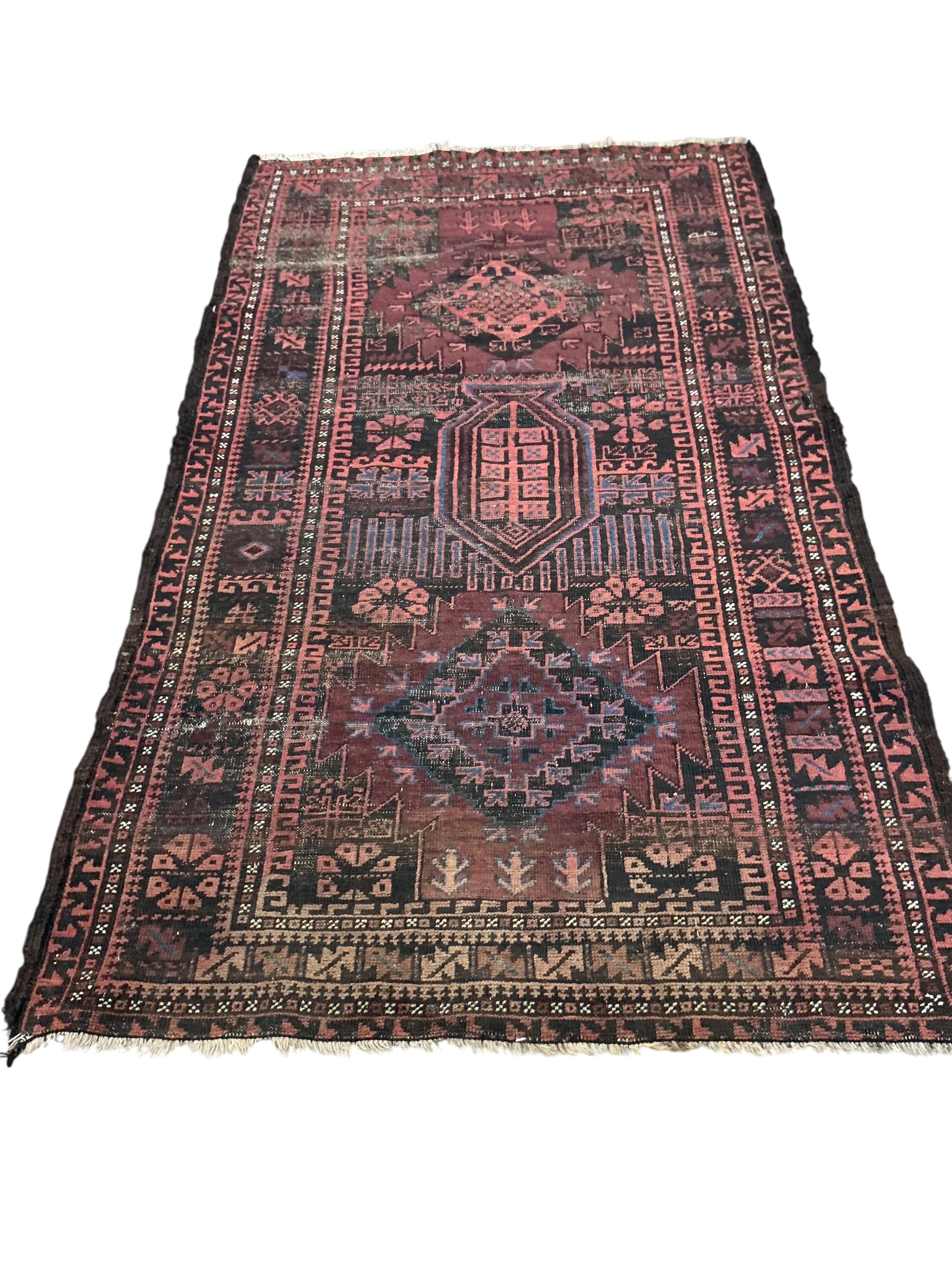 Two Belouch tribal rugs and an Afghan tribal rug, largest 200 x 110cm